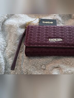Bebe Embossed Wristlet Clutch in Merlot